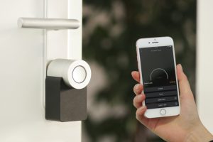Self-Storage Management Software for Security Hand holding a mobile phone, remotely managing the smart lock of the storage
